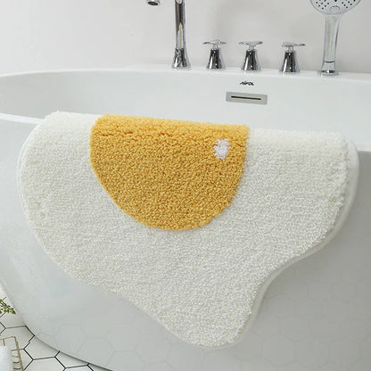 Stylish and absorbent egg-shaped doormat in various sizes and colors, made of plush polyester with a non-slip rubber backing