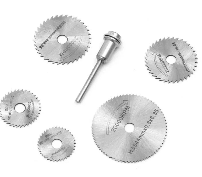 Six circular saw blades and a mandrel on a white background