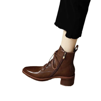Women's black pointed toe short tube boots with a 5.5cm heel on a white background.