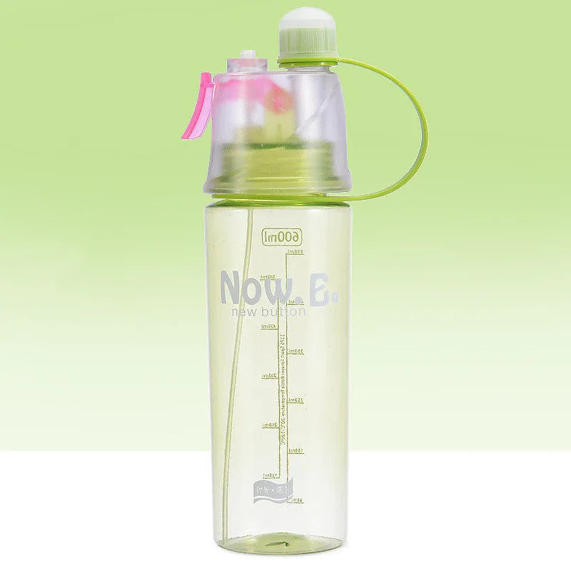Green mist spray sports water bottle with handle, scale, and press-top lid on a gym bench.