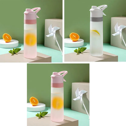 White spray water bottle with black leakproof lid and handle strap on a table