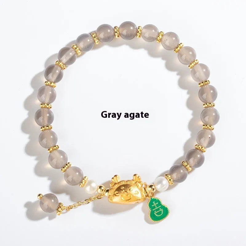 Natural agate and crystal bracelet with 8mm diamond-cut beads on a wrist.