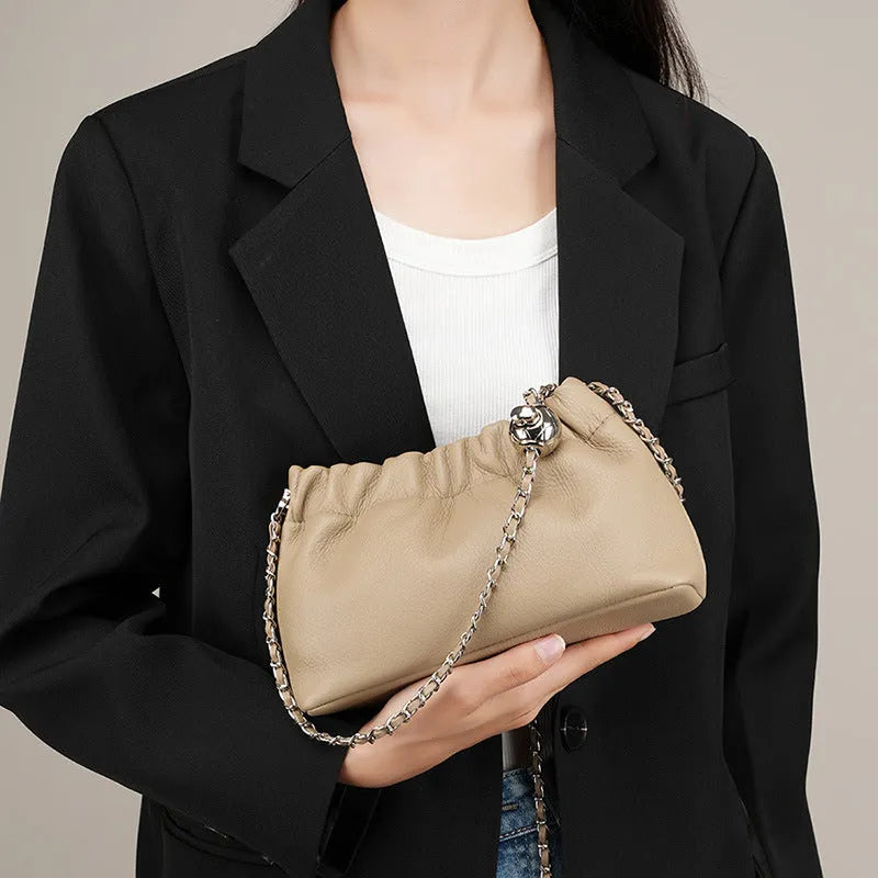 Women's dumpling-shaped genuine leather crossbody bag in three neutral colours showing slit pocket