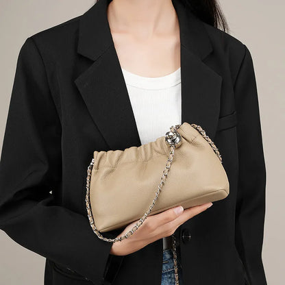 Women's dumpling-shaped genuine leather crossbody bag in three neutral colours showing slit pocket