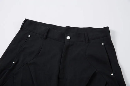 Men's black cotton pleated casual trousers with a loose-fitting wide-leg silhouette.