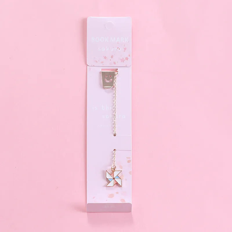 Alloy metal cartoon pendant bookmark with colourful charms including panda, rocket, and wishing bottle designs