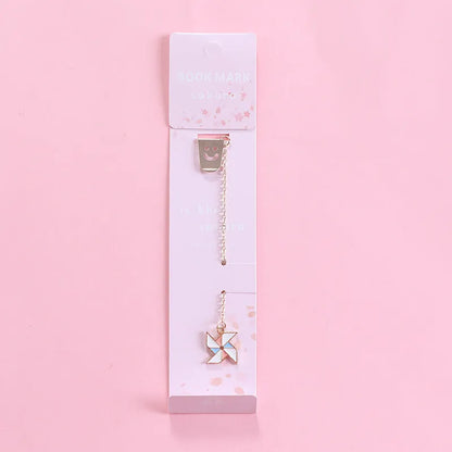 Alloy metal cartoon pendant bookmark with colourful charms including panda, rocket, and wishing bottle designs