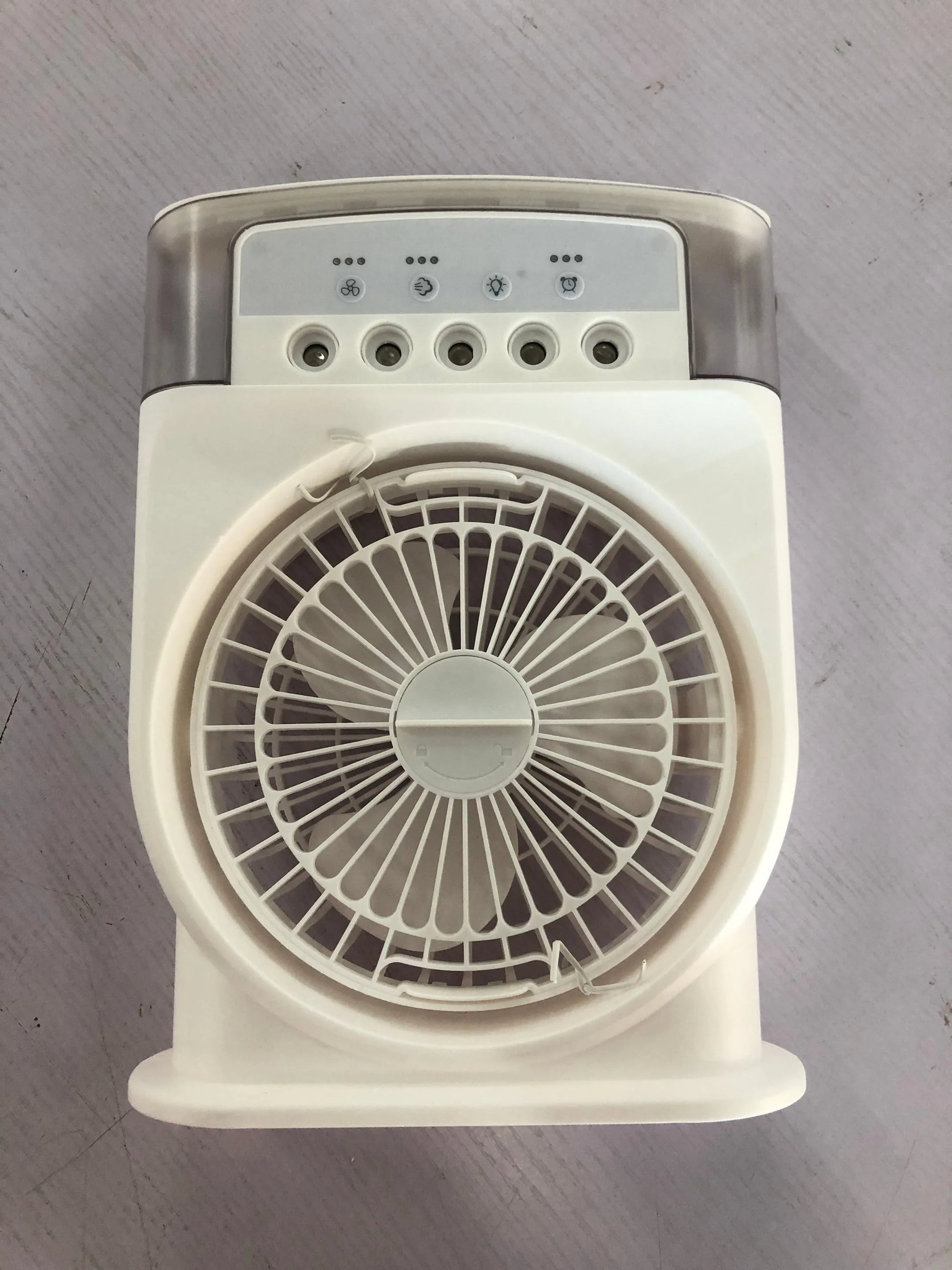 Black portable USB air cooler fan with adjustable head, leather handle, and removable water tank on a desk.
