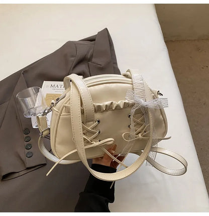 Women's PU leather casual shoulder handbag with a large bandage bow and sewing thread detail.