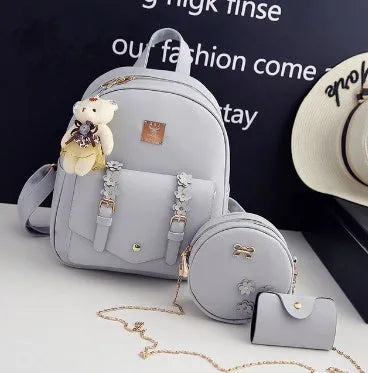 Women's black PU leather backpack, shoulder bag, and card bag set with flower designs.