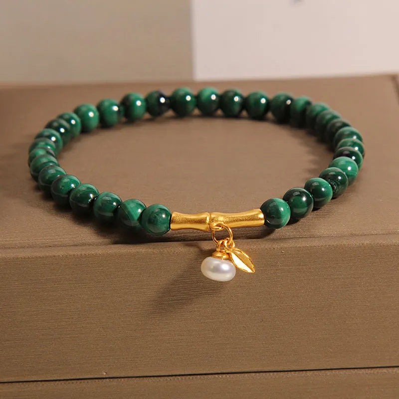 Close-up of a women's adjustable white crystal bracelet featuring a high-rise lucky bamboo design on a wrist.