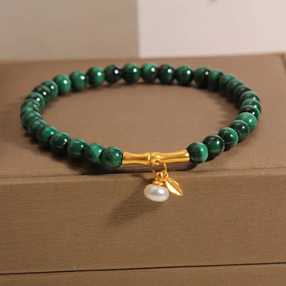 Close-up of a women's adjustable white crystal bracelet featuring a high-rise lucky bamboo design on a wrist.