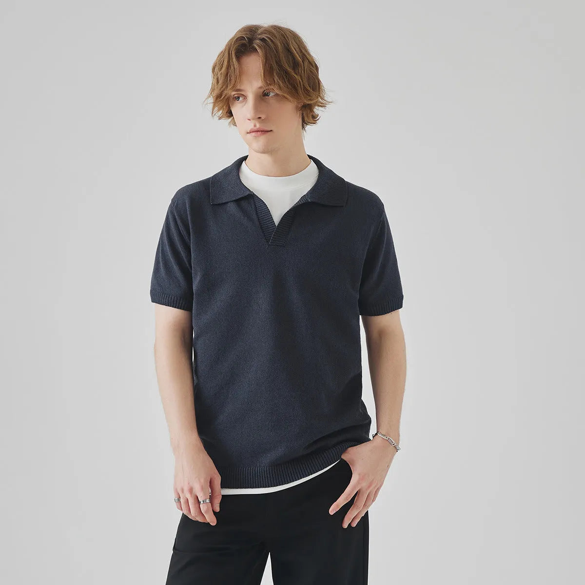 Knitted short-sleeved polo collar casual T-shirt in a solid colour on a hanger.