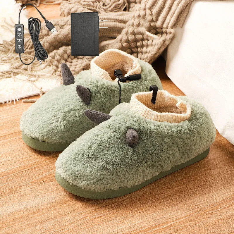 USB heating slippers in black plugged into a laptop, showing the cable and soft velvet upper.