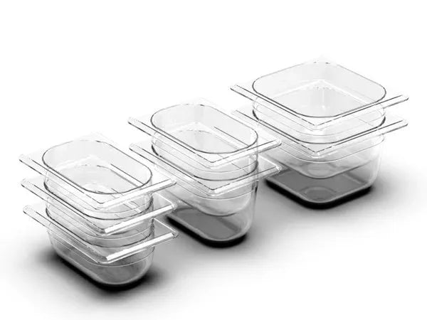 Bamboo cutting board with smooth surface alongside two large and three small plastic storage trays for vegetables and meat.