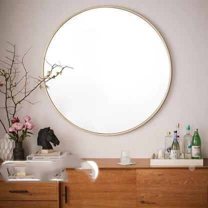 Round metal-framed wall mirror in black, white, or gold for bathroom.