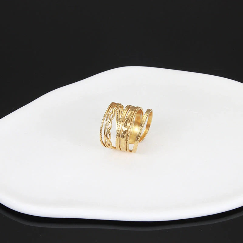 Adjustable stainless steel finger ring with unique charm designs in steel and gold finishes