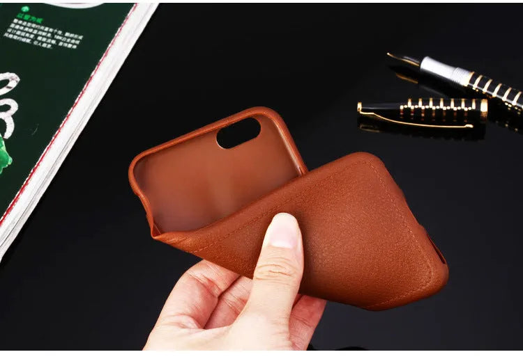 Leather-textured TPU phone case for iPhone in black, brown, navy blue, or wine red colour options.