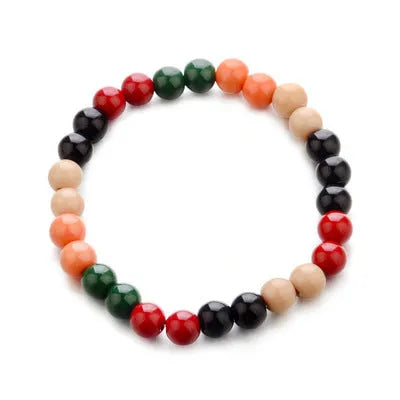 An ethnic-style natural stone bead bracelet with lava stones on a wrist.
