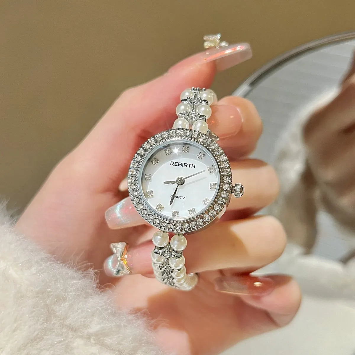 Women's vintage freshwater pearl bracelet watch with 25mm dial, steel strap, and double row pearl design in silver
