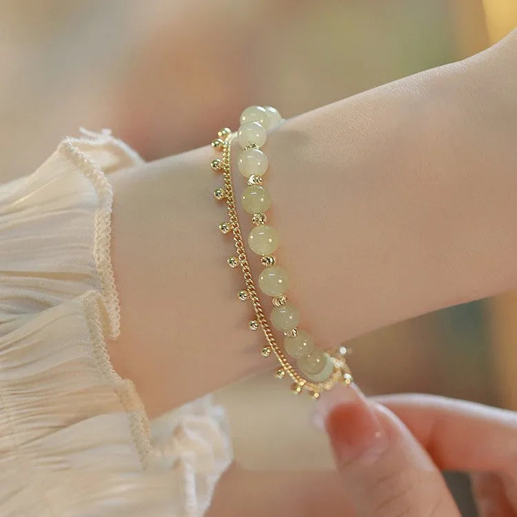 Handmade natural Hetian Jade women's bracelet in a classic beaded style.
