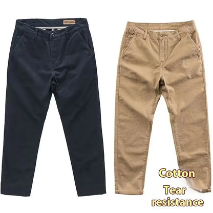 Man wearing slim fit grey micro elastic washed trousers with a straight leg cut for a business casual look.