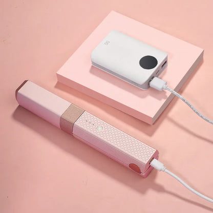 Pink and green cordless mini USB hair straightener and curler with ceramic plates.