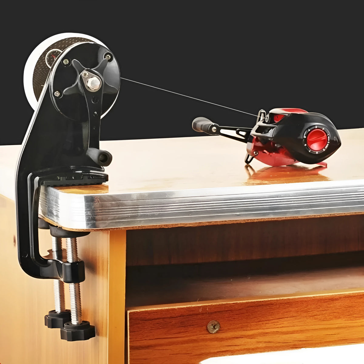 Black fishing line cable winder with extension shaft on composite fibre construction