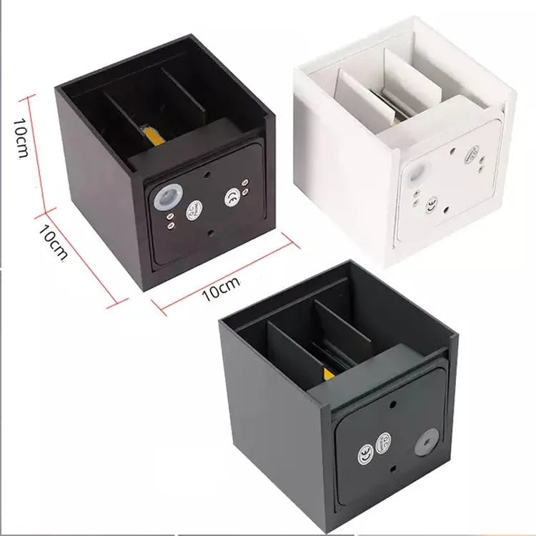 Compact square aluminium wall lamp with 360-degree light output, shown in grey finish mounted on a wall.