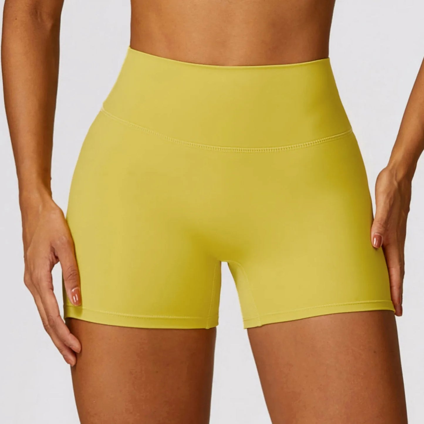 Women's high waist yoga shorts in nylon fabric with belly contracting design and hip lifting cut