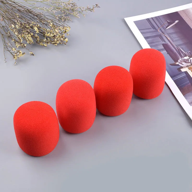 Four foam microphone wind shields in different colours for handheld stage microphones