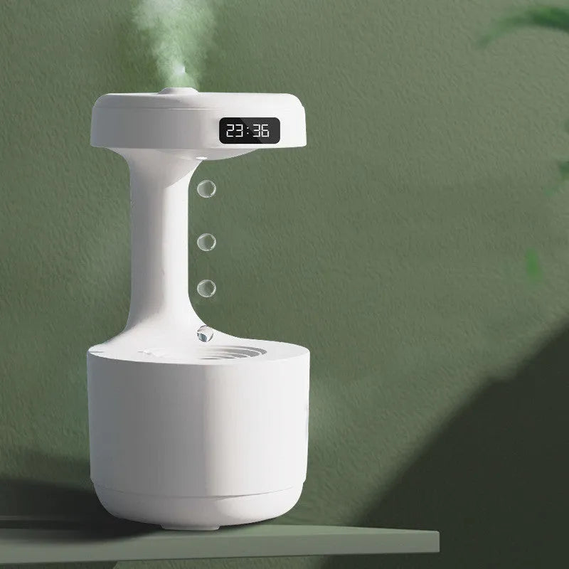 White columnar anti-gravity humidifier with water droplet backflow and LED clock display on a desk.