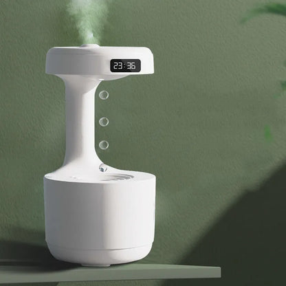 White columnar anti-gravity humidifier with water droplet backflow and LED clock display on a desk.