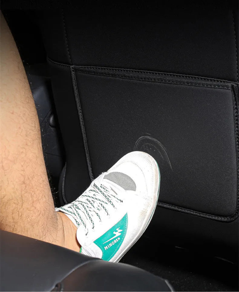 Rear anti kick pad to prevent dirt, a leather seat kick pad measuring 68cm long and 42cm wide for full coverage protection on the middle of car seats, sold in a pair of two.