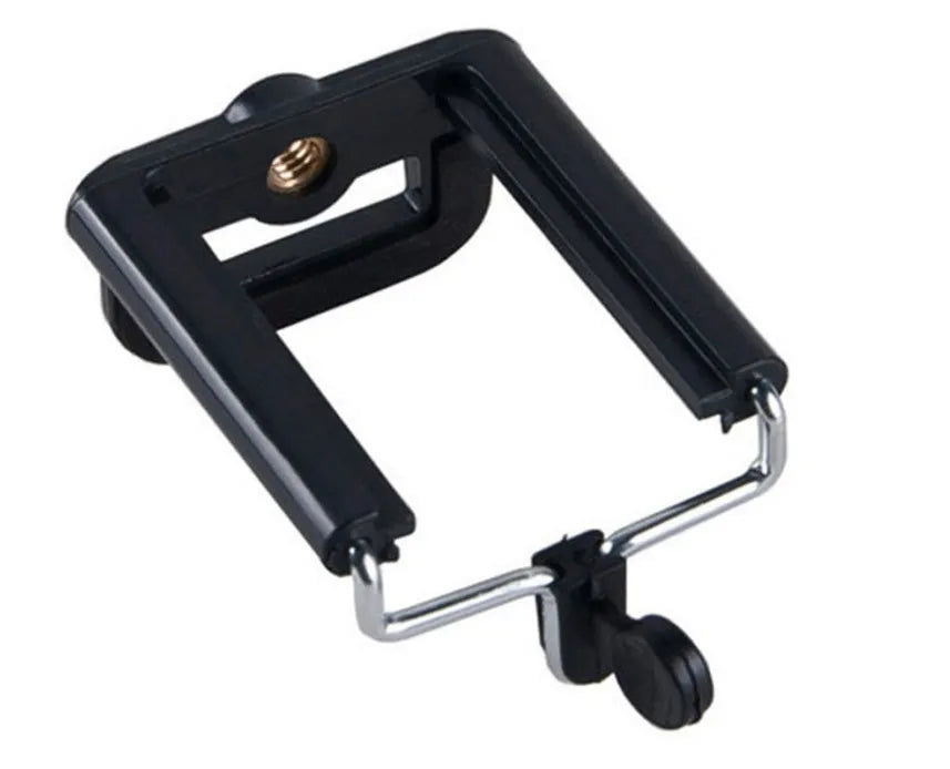 Black mini camera tripod with extended legs and a separate U-shaped universal phone clip on a table.