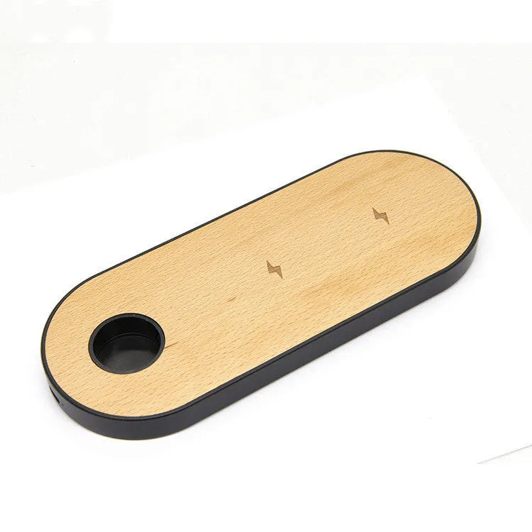 Ultra-thin bamboo and wood wireless charging stand for smartphones on a desk.