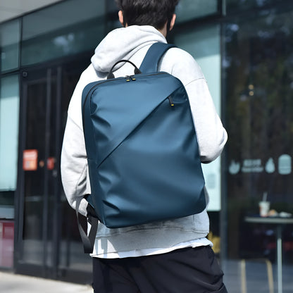 Large black waterproof PU leather laptop backpack with sewing thread details on a simple design.