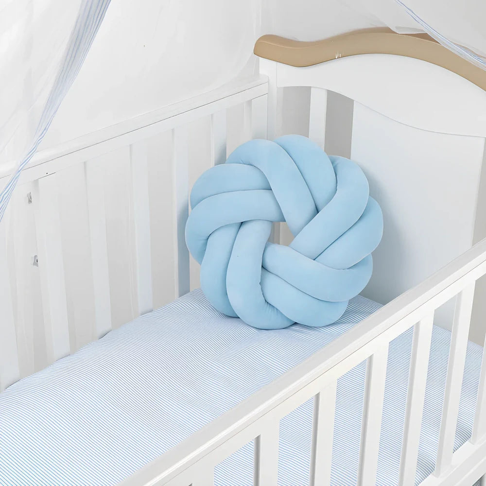 Knotted lumbar pillow with memory foam fill showing adjustable height feature and polyester cover