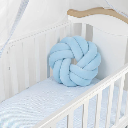 Knotted lumbar pillow with memory foam fill showing adjustable height feature and polyester cover