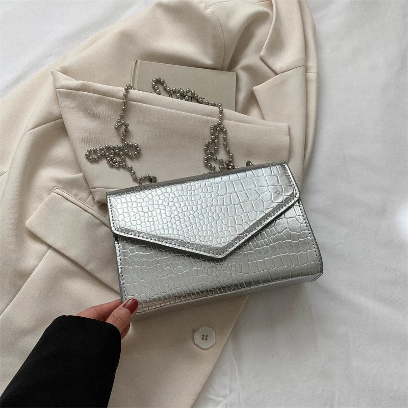 Clamshell handbag with crocodile pattern and soft handle in various colours