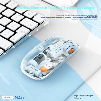 Transparent wireless computer mouse in blue on a desk next to a laptop