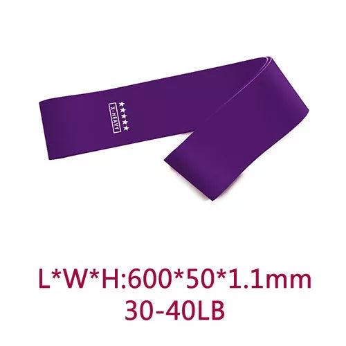 Yoga tension band set in five colours with varying resistance levels for fitness and Pilates