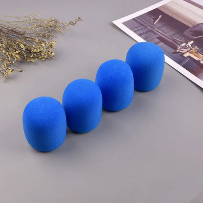 Four foam microphone wind shields in different colours for handheld stage microphones