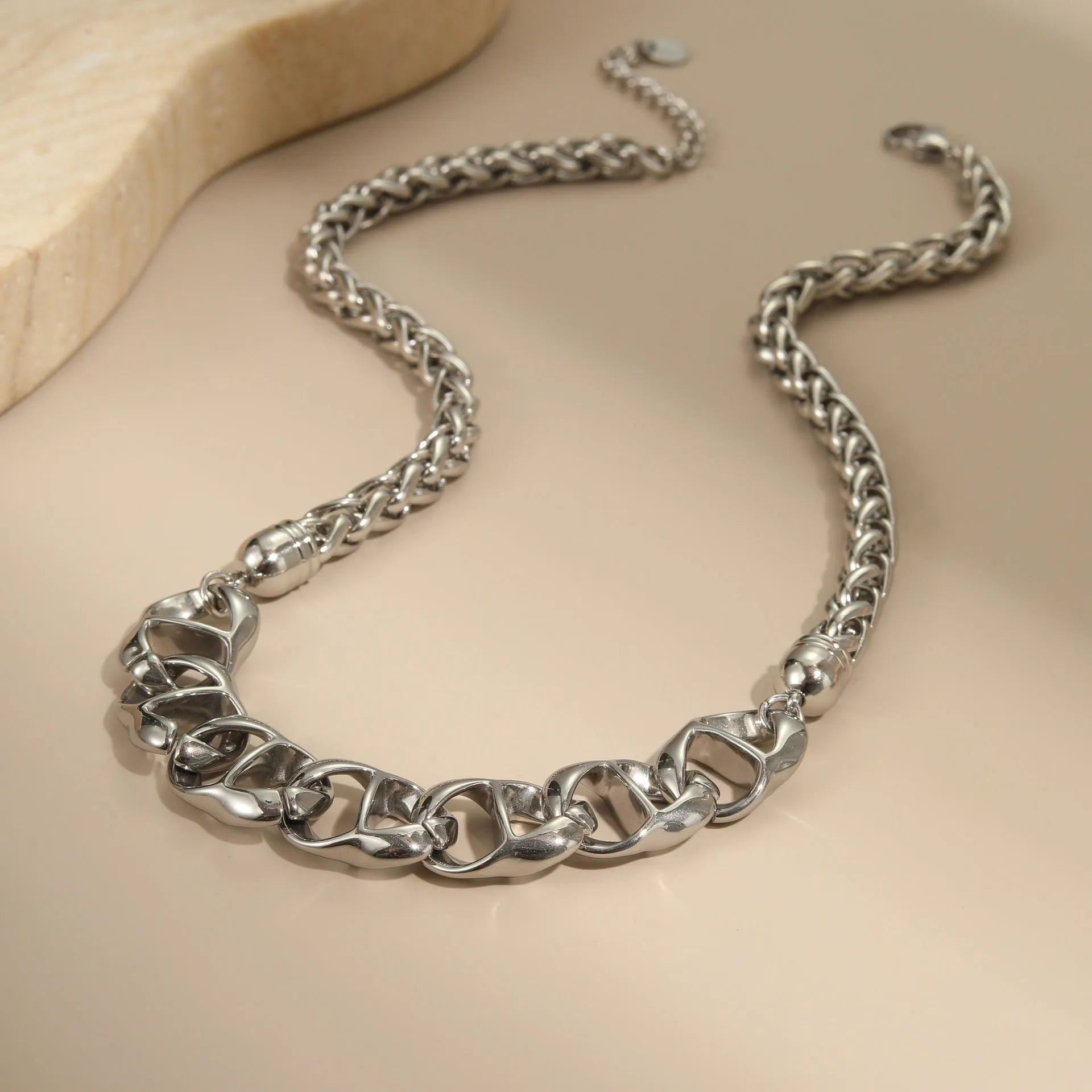 Gold plated stainless steel necklace with geometric pendant for women, shown in two colour options.
