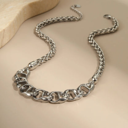 Gold plated stainless steel necklace with geometric pendant for women, shown in two colour options.