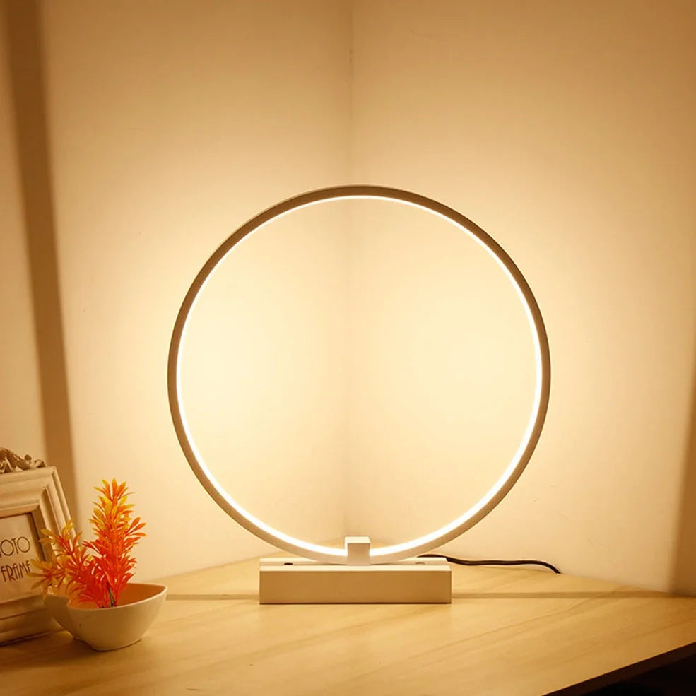 Modern 25cm diameter white LED bedside lamp with acrylic frame and iron base, emitting cool or warm white flicker-free light