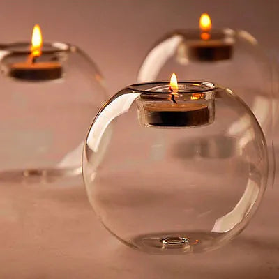 Handmade hollow round glass candle holder in European style on a table.