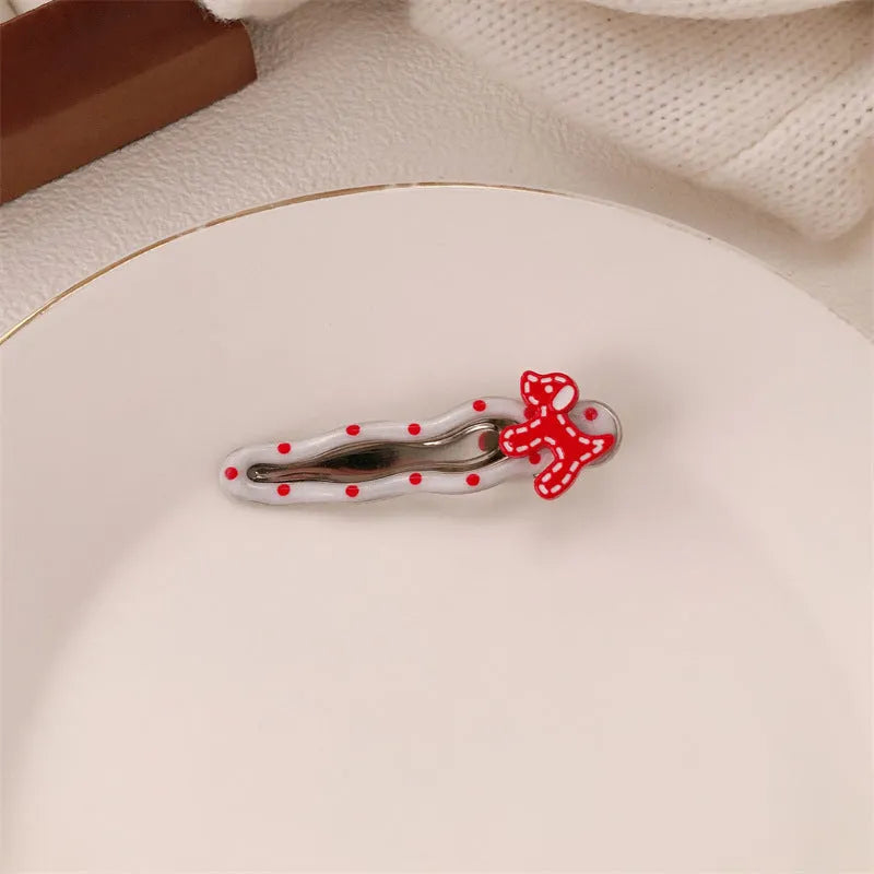 Red love heart-shaped hair barrette clip with retro white dots on a willow leaf-shaped base.