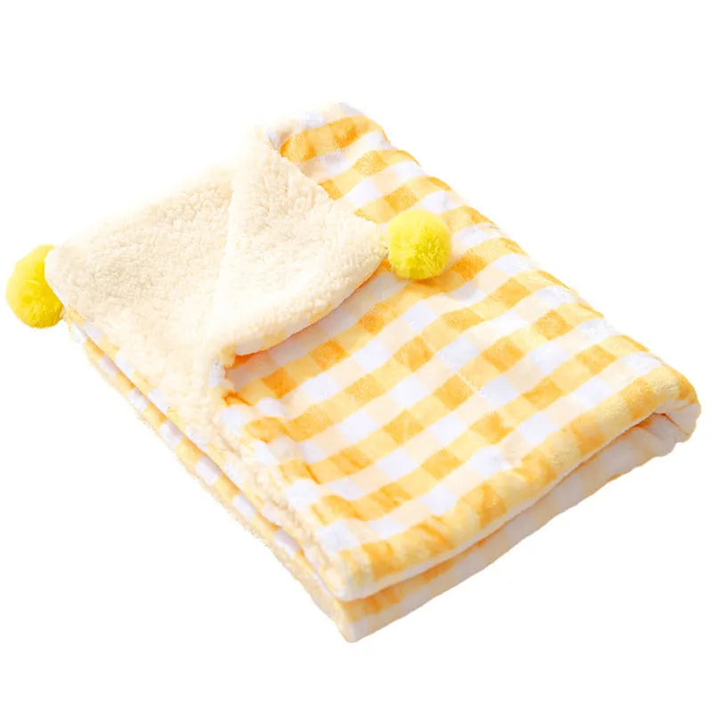 A blue coral fleece pet blanket laid flat, showing its soft texture and rectangular shape as a dog or cat bed mat.