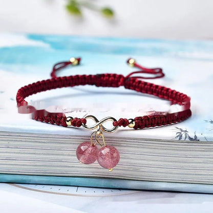 Women's adjustable bracelet with natural strawberry quartz cherry-shaped crystal charms on a chain.